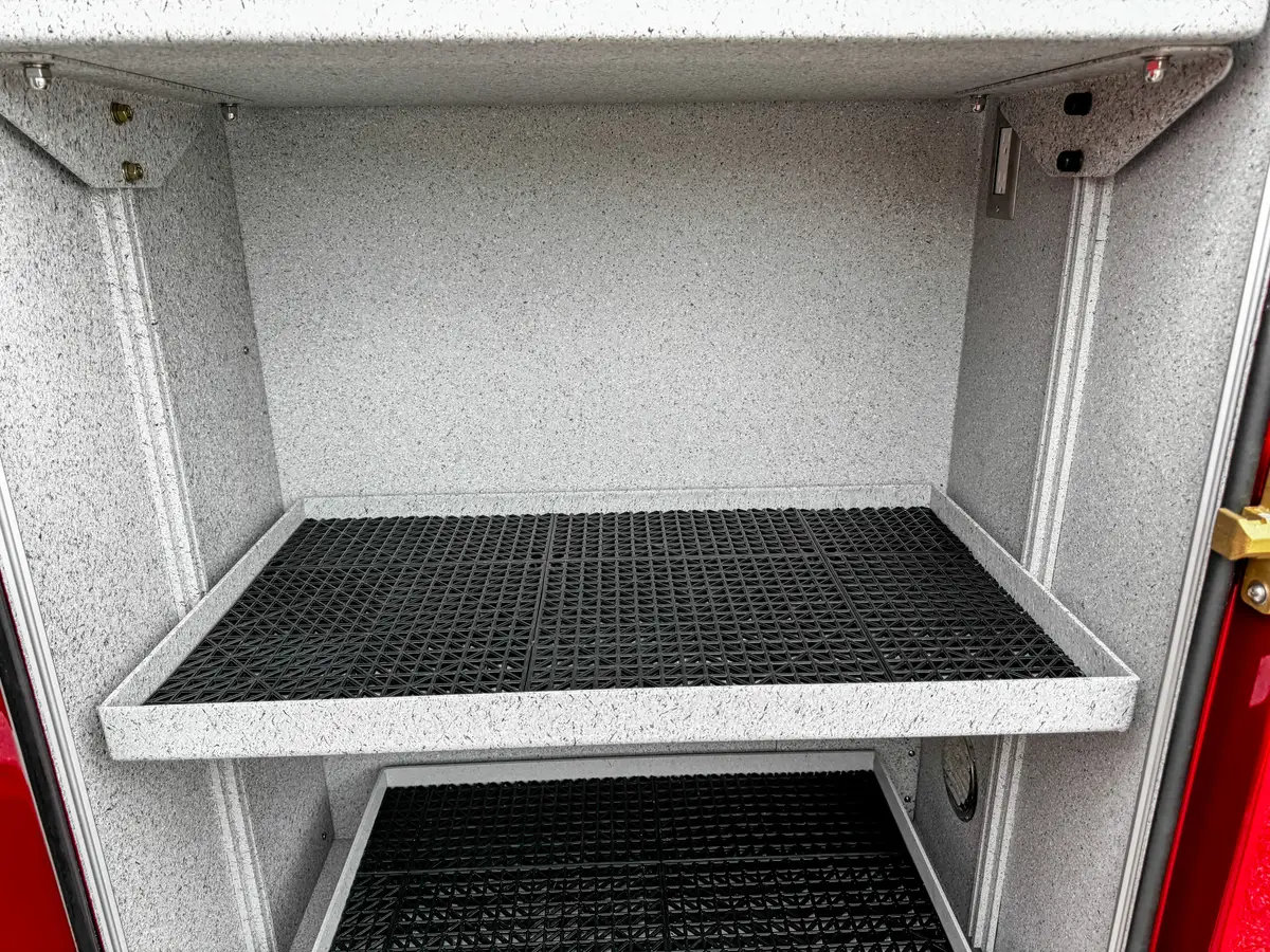 Deep lower compartment interior close-up with vent and side wiring.